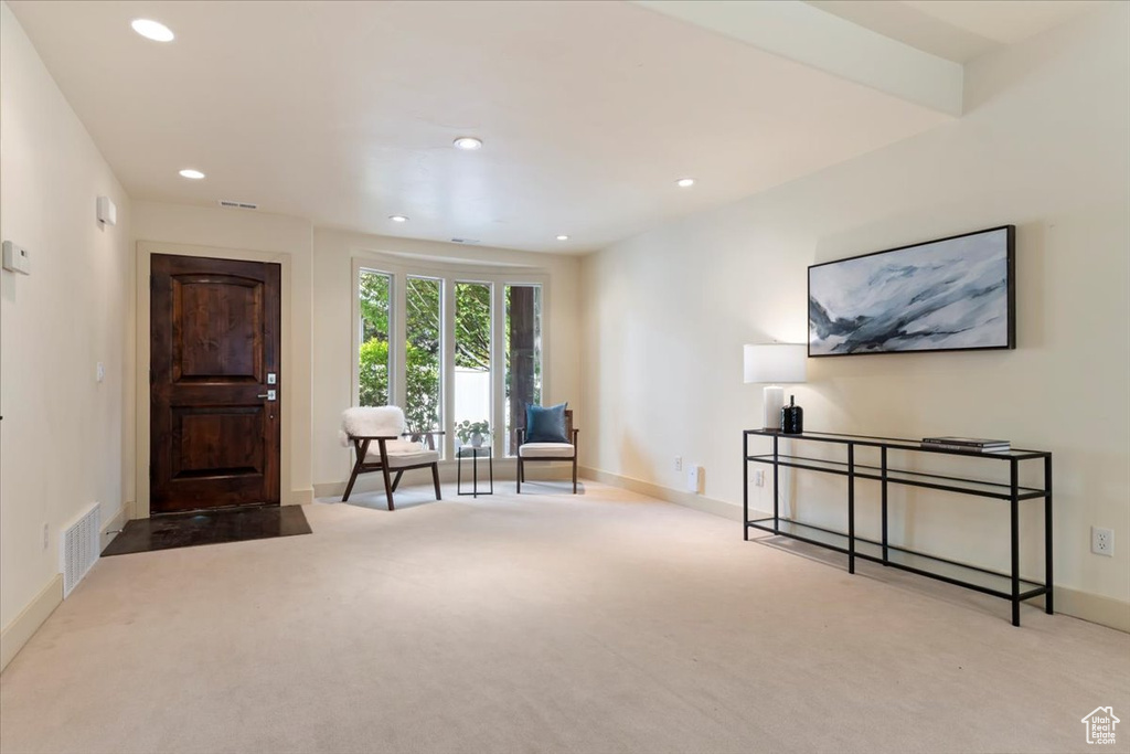 Living area with carpet flooring, baseboards, and recessed lighting