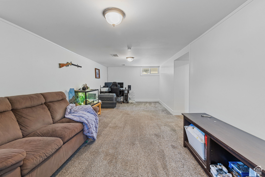 Living room with a desk, carpet, and ornamental molding