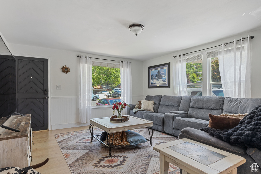 Living area with light wood-style flooring and wainscoting