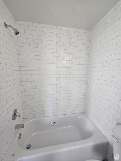 Bathroom with tub / shower combination and toilet