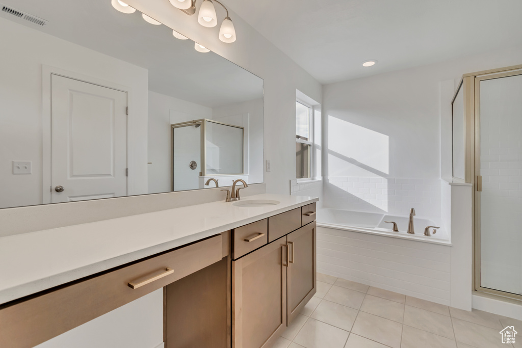 Bathroom featuring vanity, a stall shower, a bath, tile patterned floors, and recessed lighting