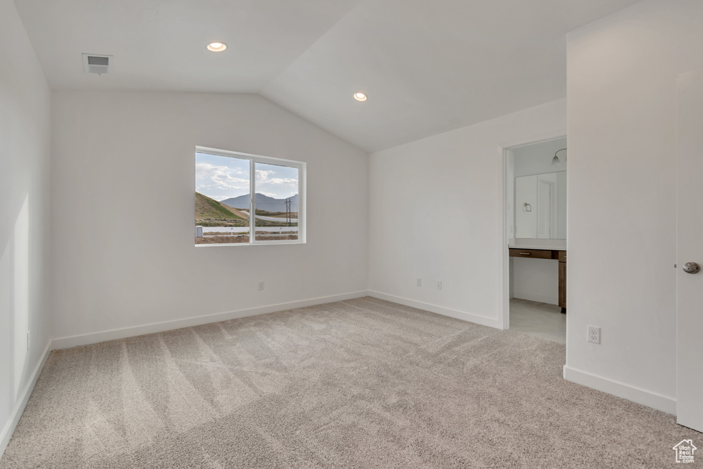 Unfurnished bedroom with light colored carpet, lofted ceiling, and recessed lighting