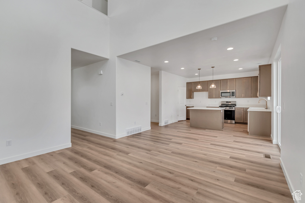 Unfurnished living room featuring light wood-type flooring and recessed lighting