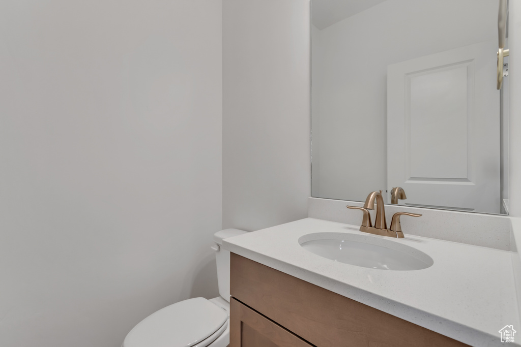 Half bath featuring vanity and toilet