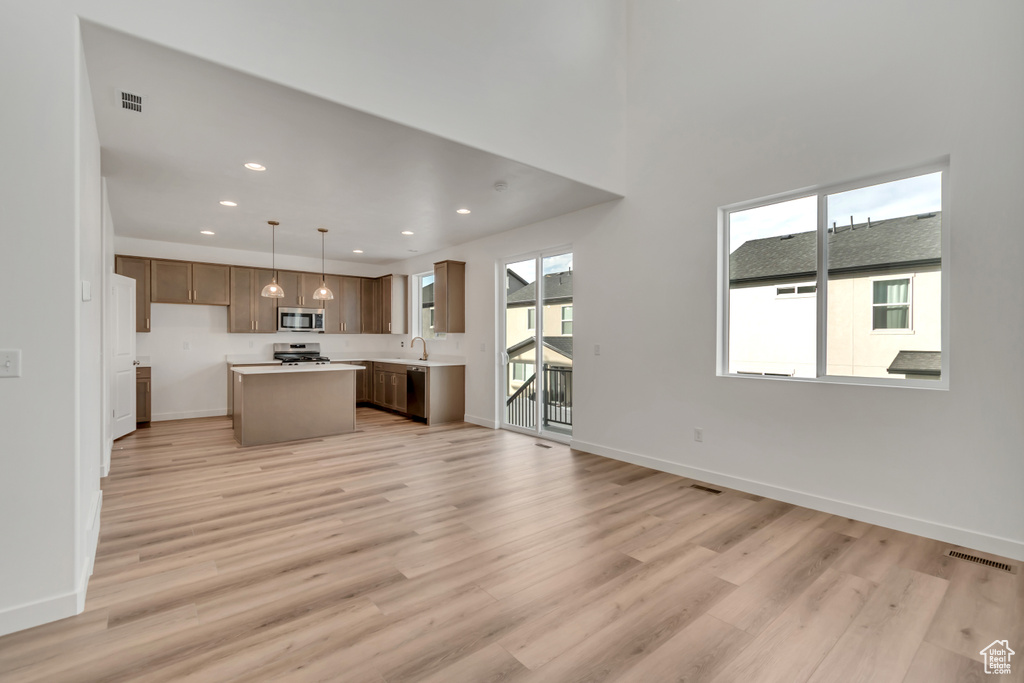 Unfurnished living room with light wood finished floors and recessed lighting