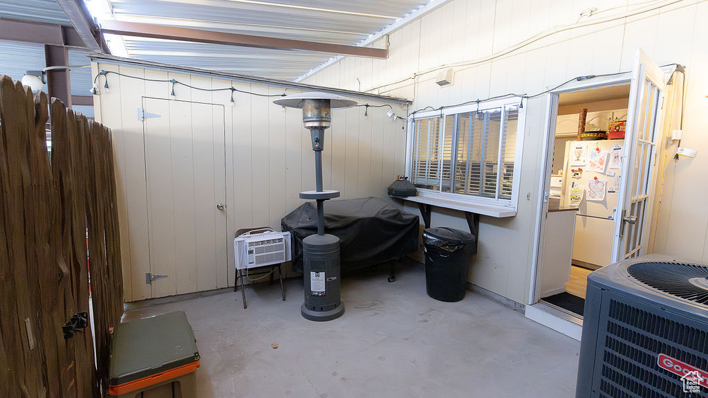 Below grade area featuring freestanding refrigerator