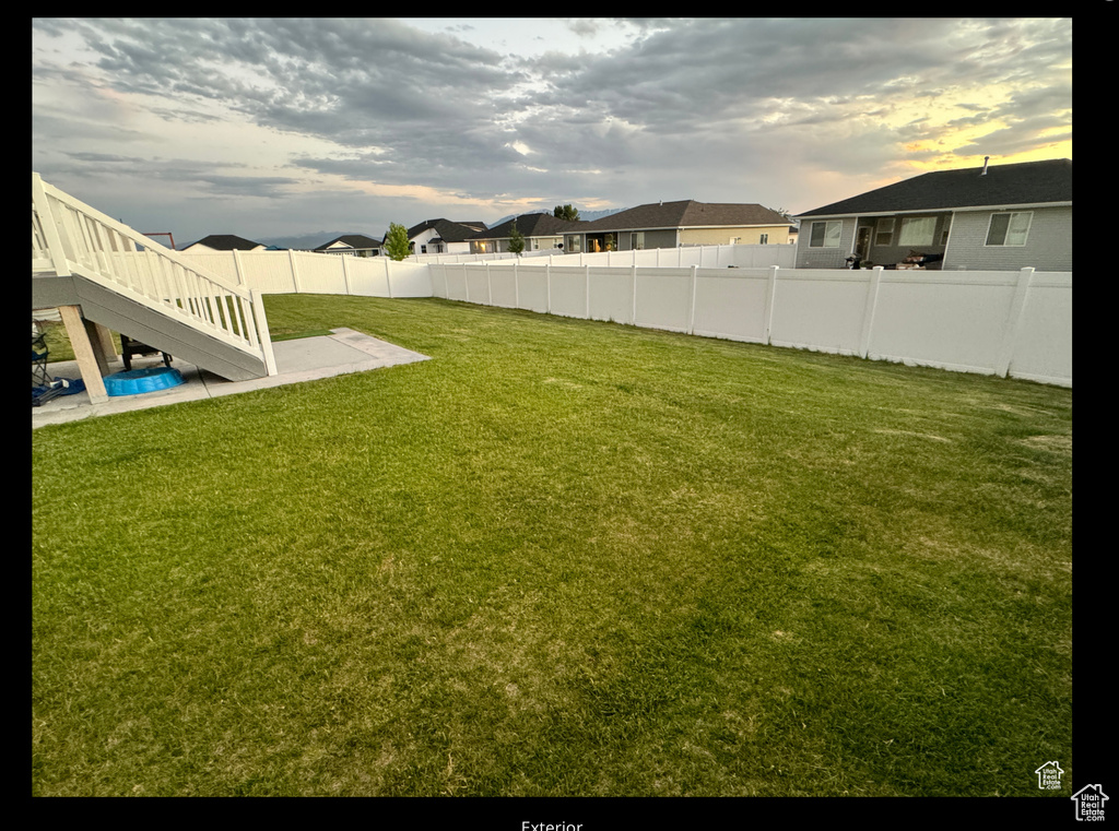 View of yard with a fenced backyard and a residential view