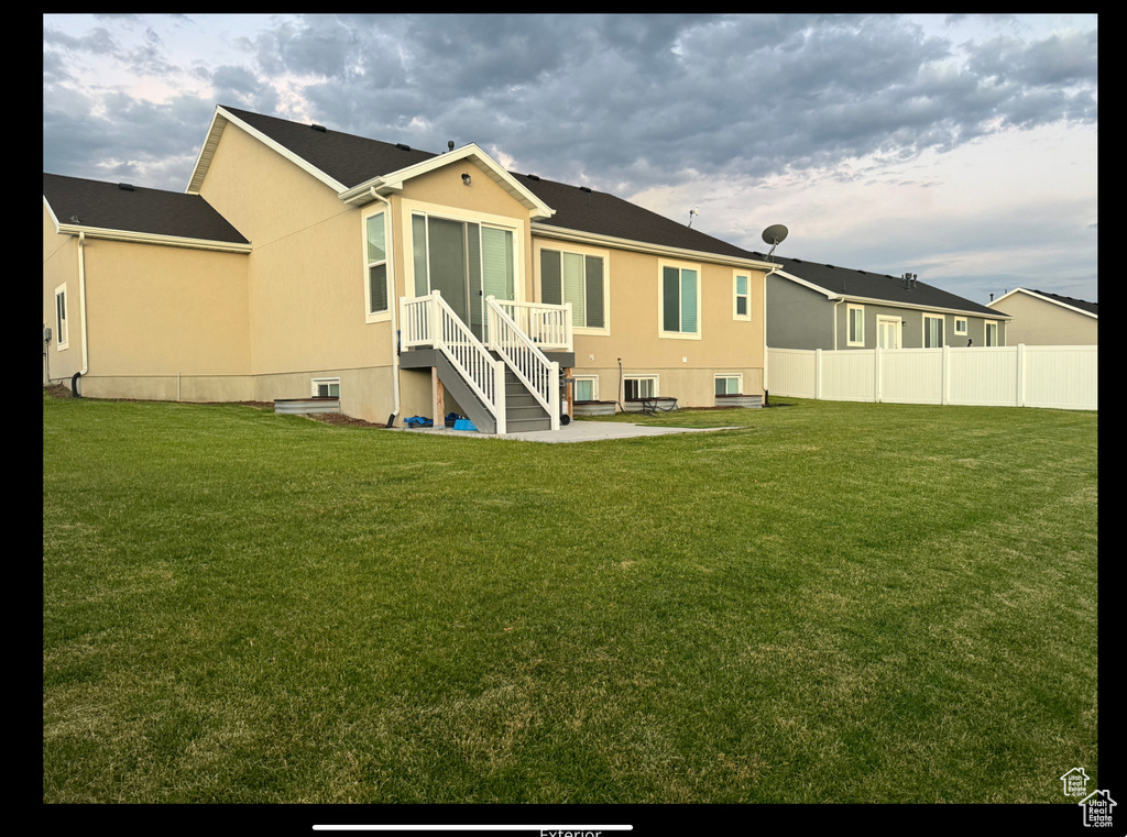 Back of property featuring stucco siding