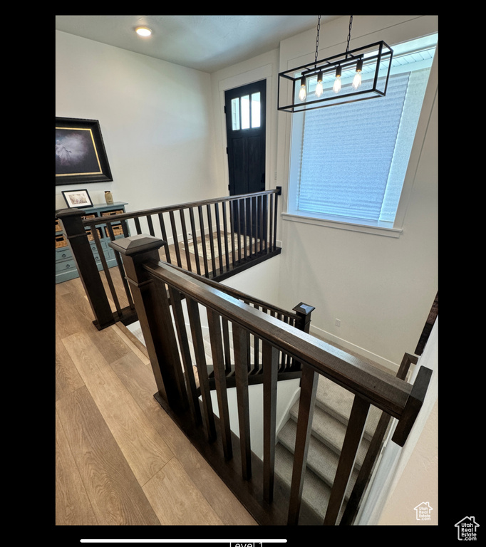 Staircase featuring wood finished floors