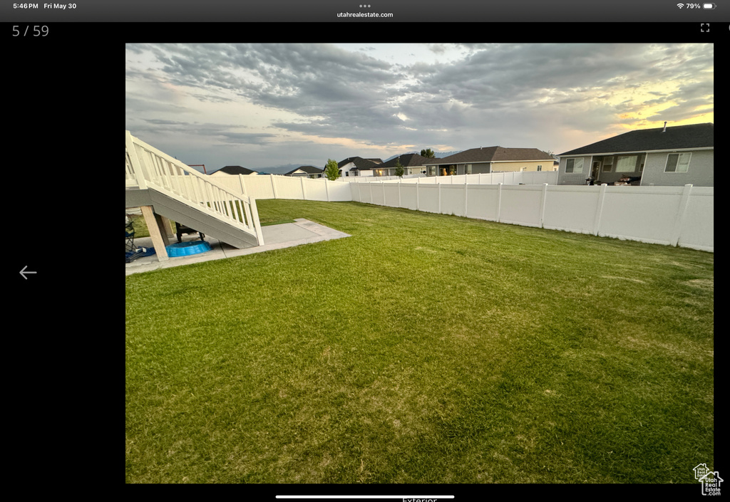 View of yard featuring stairs and a residential view