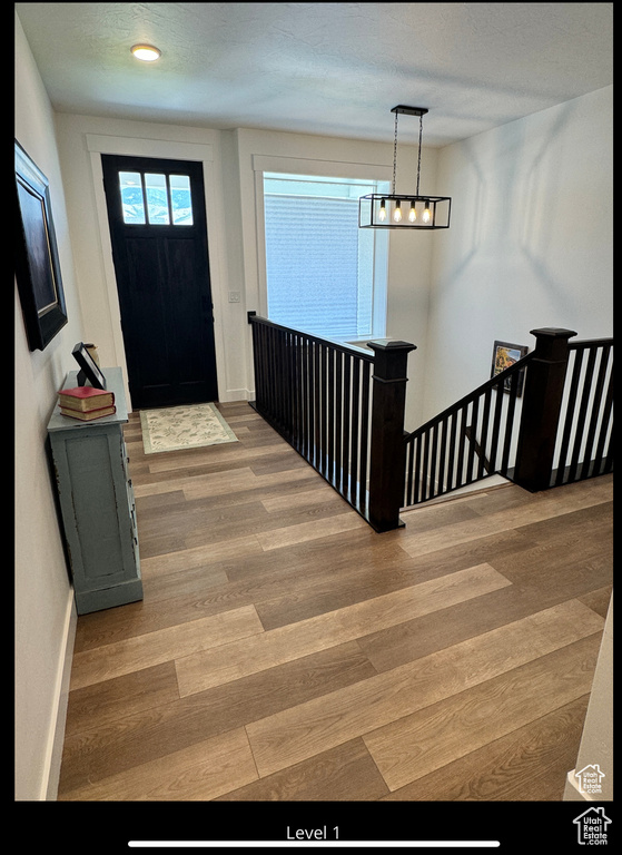 Foyer entrance featuring baseboards and wood finished floors