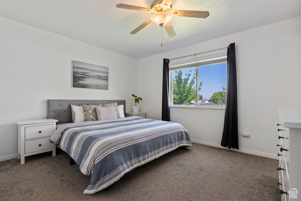 Bedroom featuring carpet floors, baseboards, and a ceiling fan