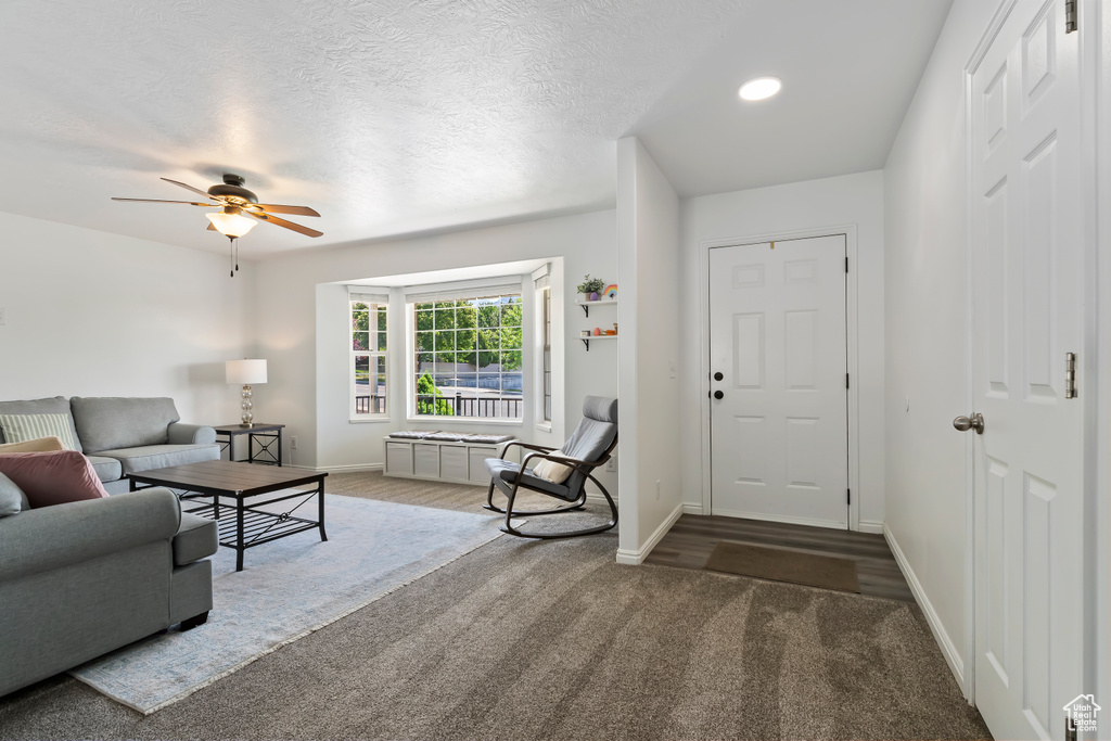 Living area featuring a ceiling fan, baseboards, carpet, and recessed lighting