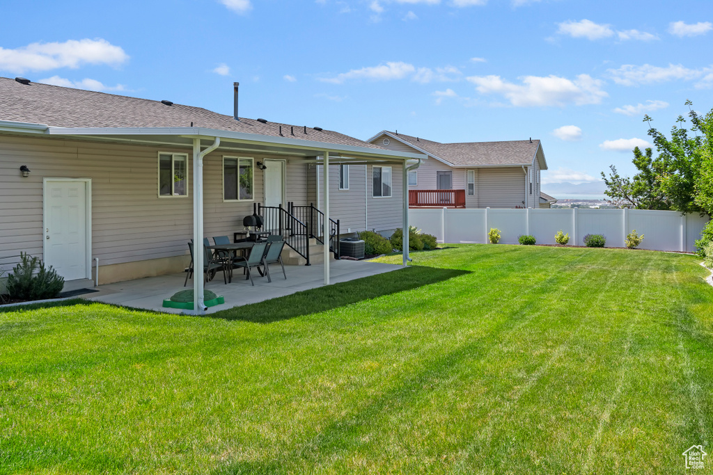 Back of house with a patio area and central AC