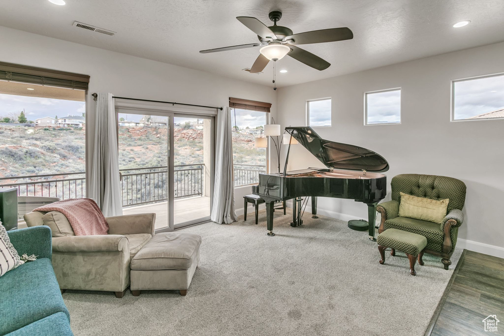 Living area featuring baseboards, a ceiling fan, recessed lighting, and wood finished floors