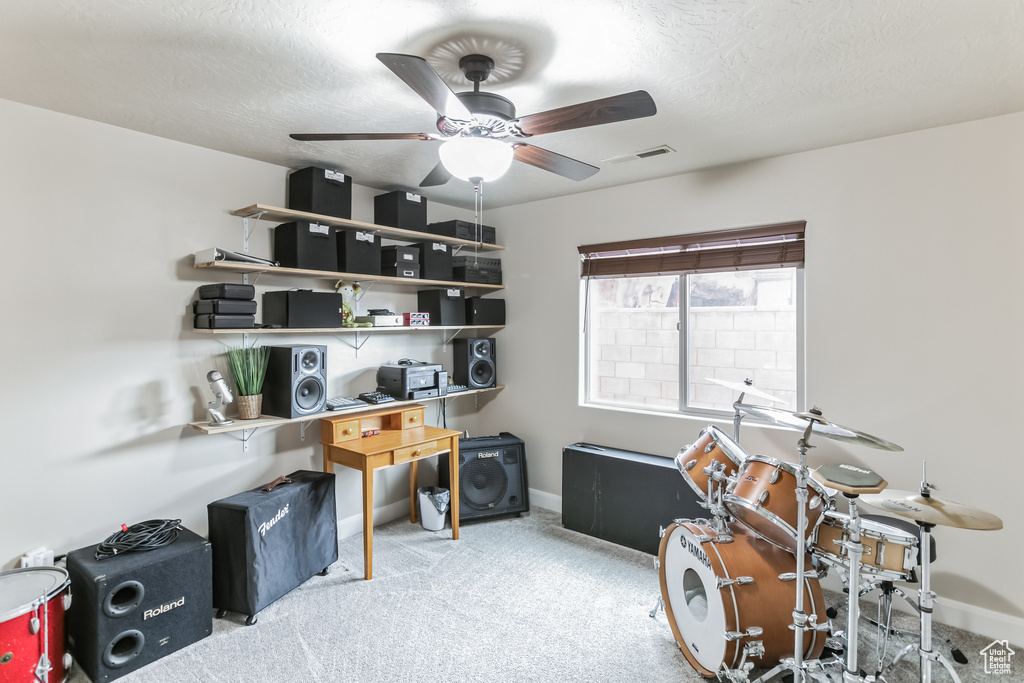 Office featuring ceiling fan, carpet flooring, baseboards, and a textured ceiling