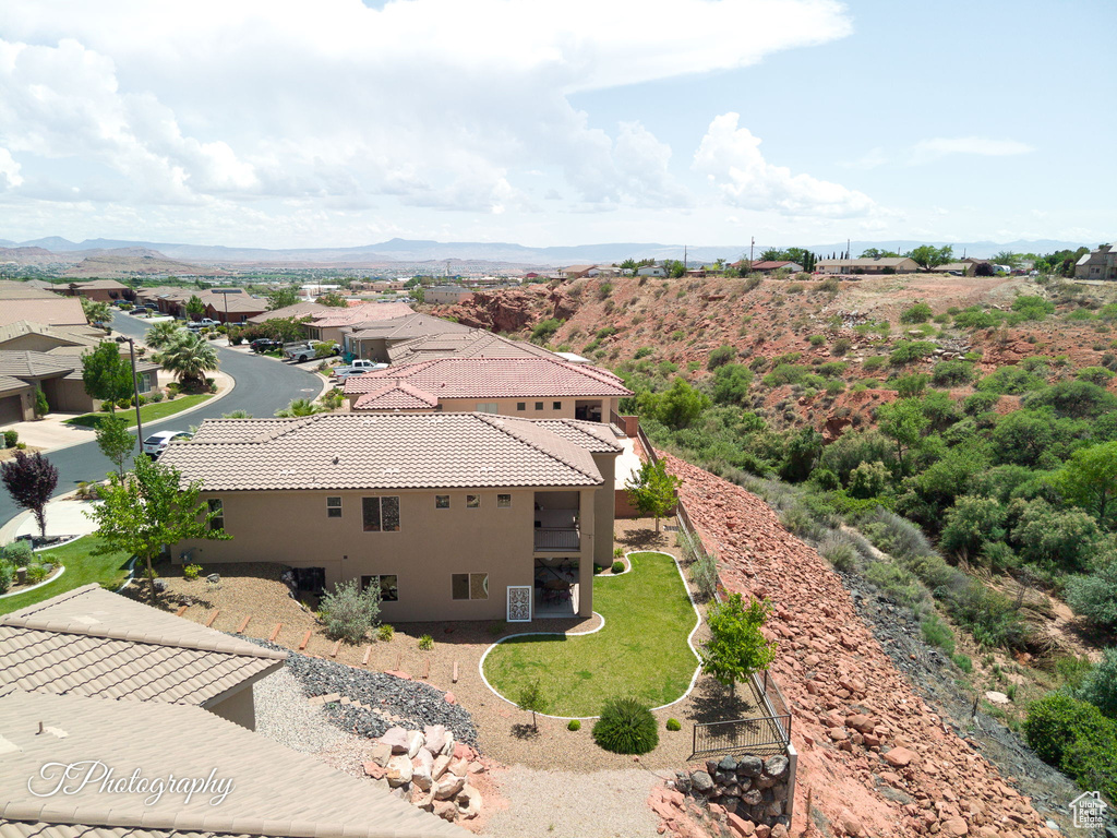 Aerial view of property and surrounding area with a mountainous background