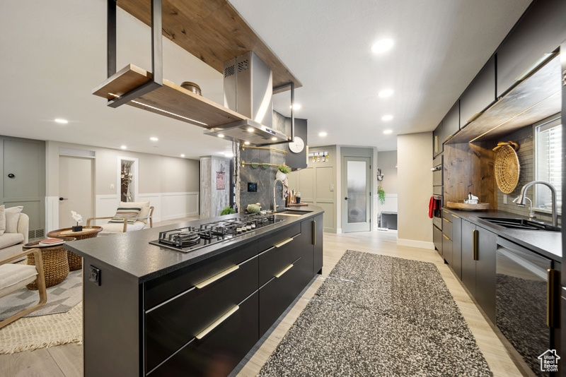 Kitchen with stainless steel appliances, a sink, dark cabinetry, modern cabinets, and recessed lighting