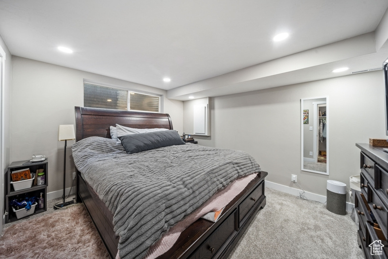 Bedroom featuring light carpet, recessed lighting, and baseboards