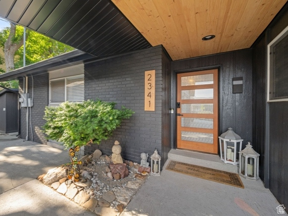 Entrance to property with brick siding