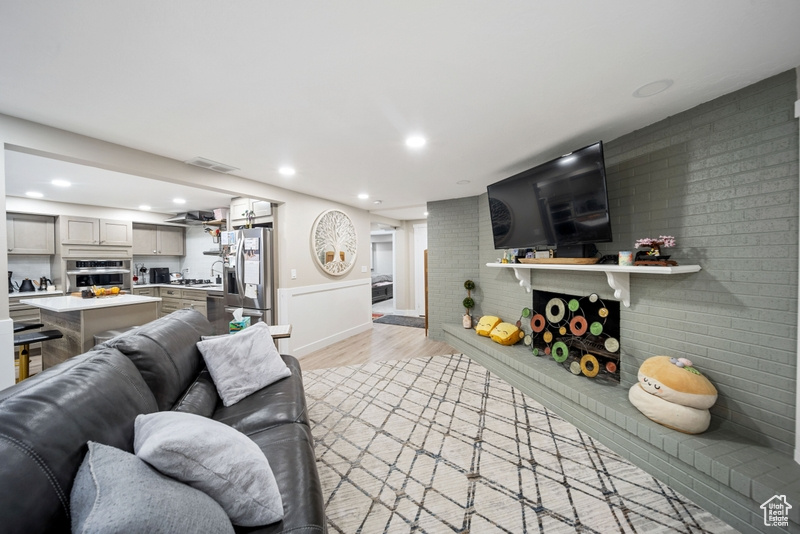 Living area featuring light wood-type flooring, recessed lighting, and baseboards