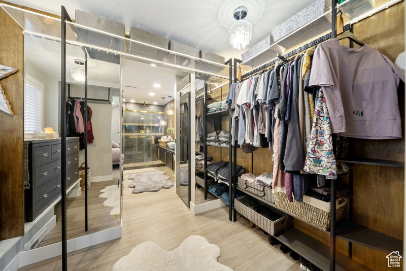 Walk in closet featuring wood finished floors