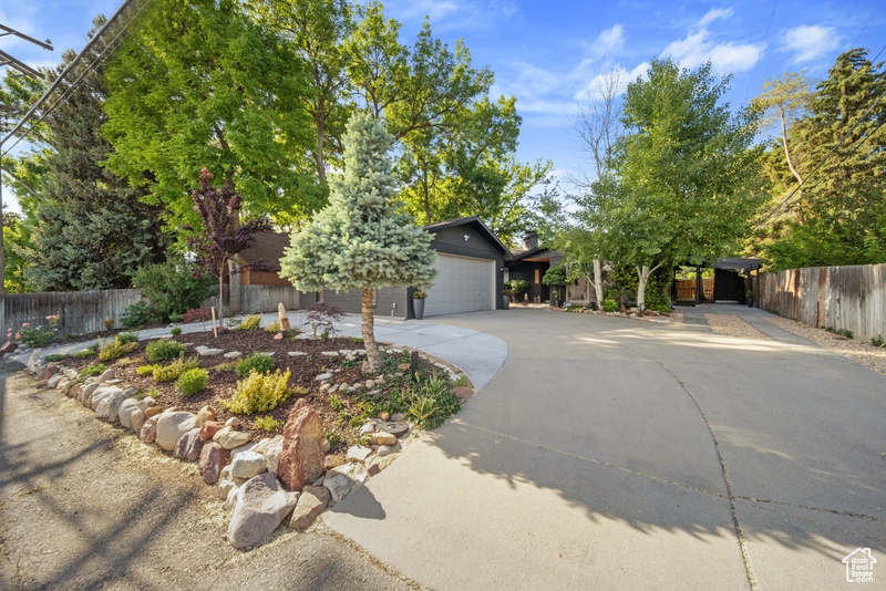 View of front facade featuring concrete driveway and a garage