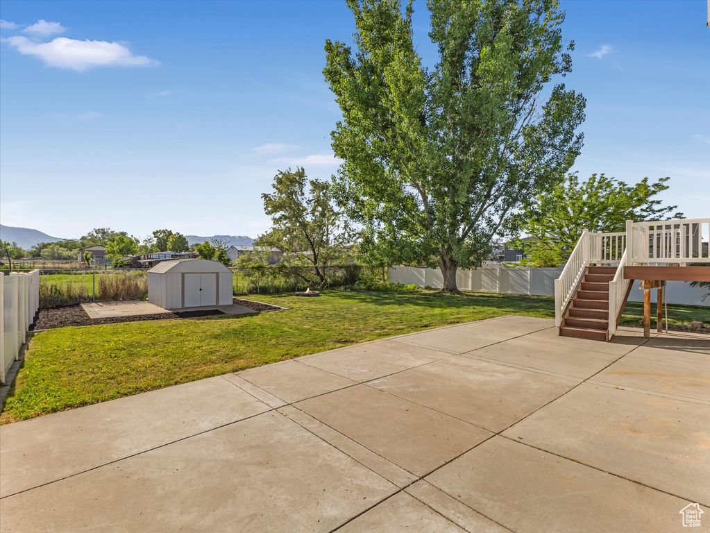 View of patio featuring stairs and a deck with mountain view