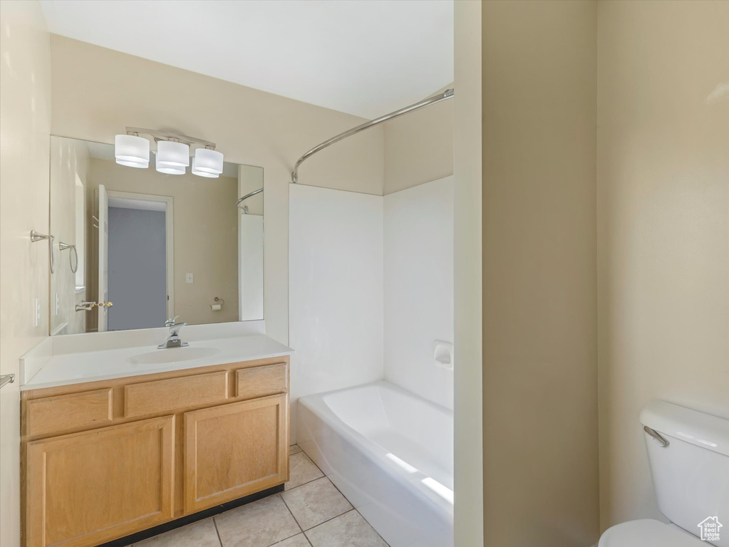 Bathroom featuring vanity, bathing tub / shower combination, toilet, and tile patterned floors