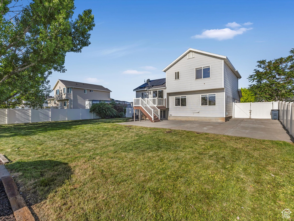 Back of house with a patio area, stairs, a gate, and a deck