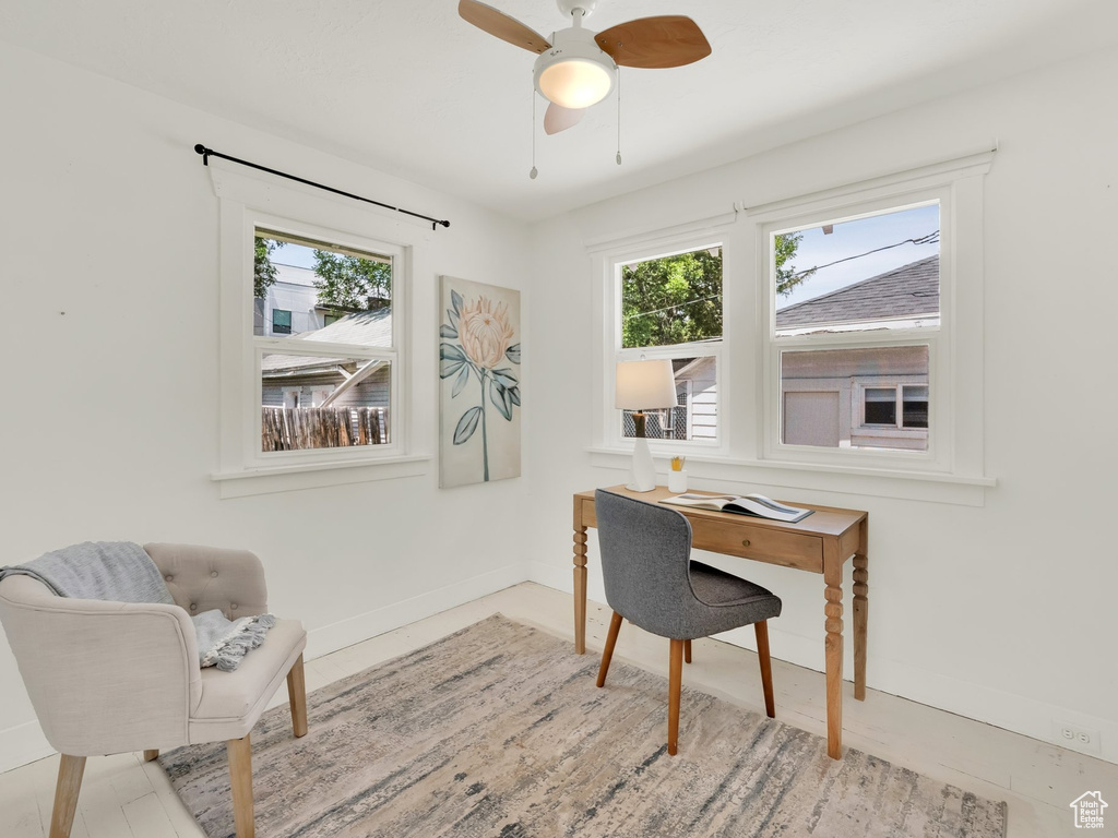 Office area with healthy amount of natural light, baseboards, and a ceiling fan
