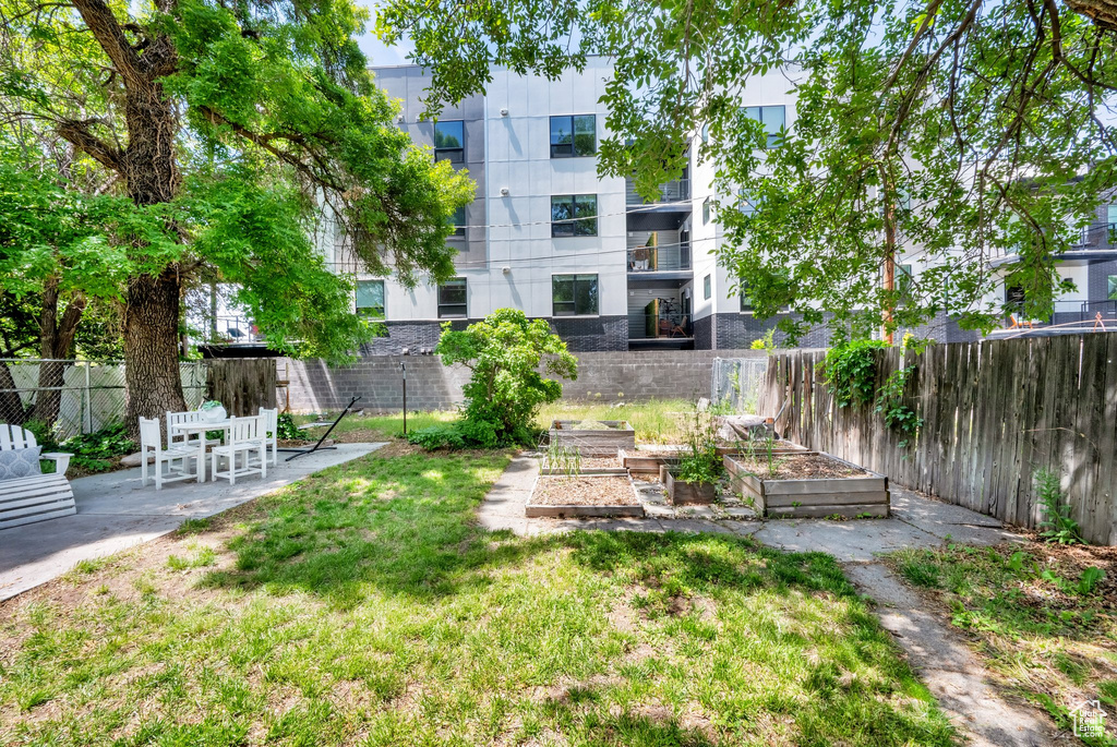 View of yard with a garden and a patio area