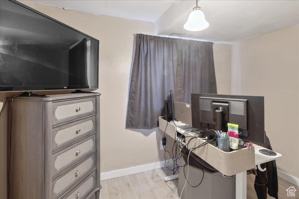 Office space with light wood-style floors and baseboards