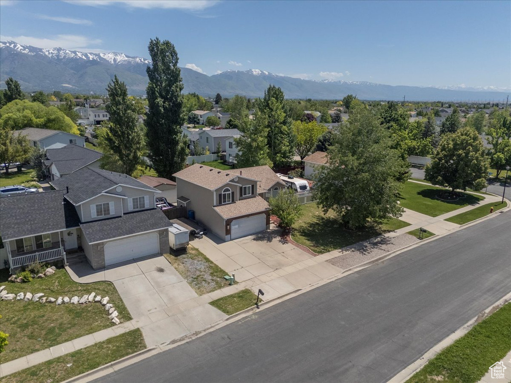 Aerial perspective of suburban area with a mountainous background