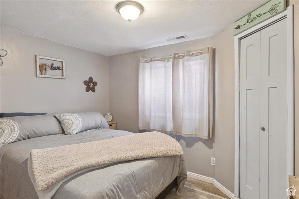 Bedroom featuring light wood-style floors and baseboards