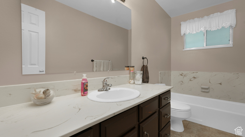 Full bathroom featuring toilet, vanity, a garden tub, and tile patterned floors