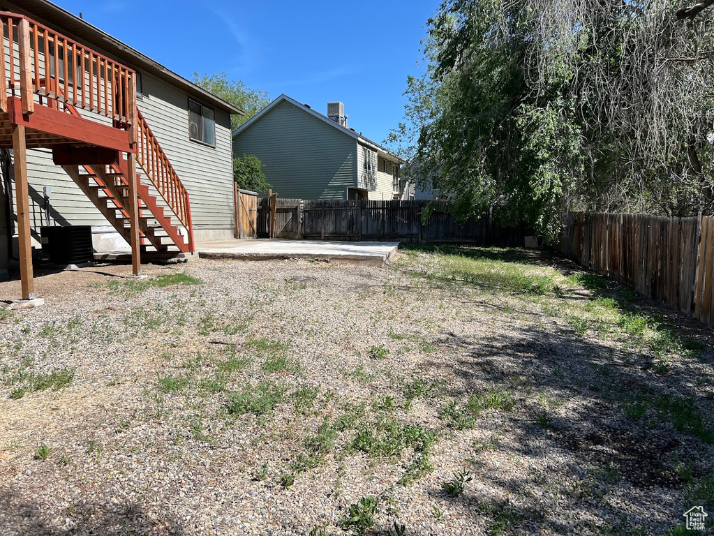 Fenced backyard featuring stairway and a wooden deck