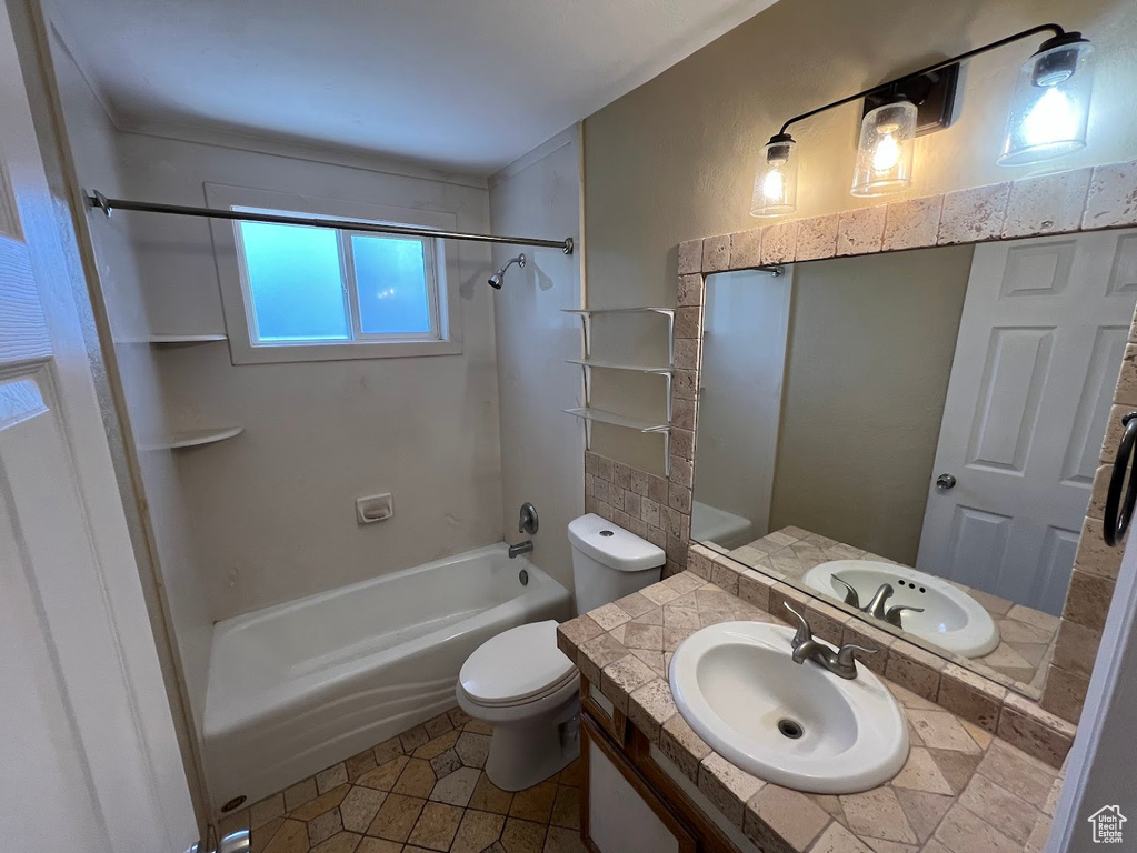 Bathroom featuring shower / bath combination, vanity, toilet, and tile patterned floors