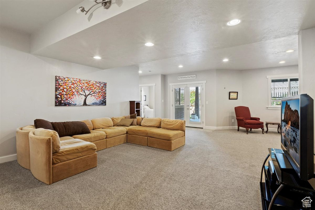 Carpeted living room featuring recessed lighting, baseboards, and plenty of natural light