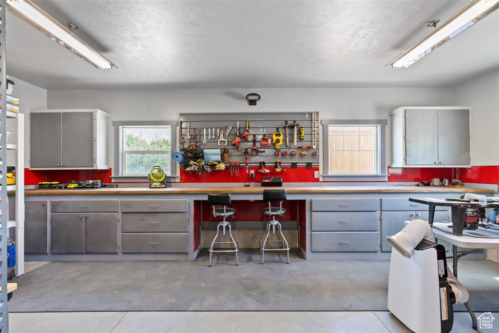 Kitchen with gray cabinets, light countertops, and a textured ceiling