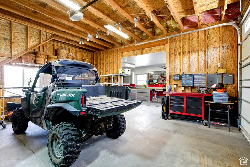 Garage featuring a workshop area and a garage door opener