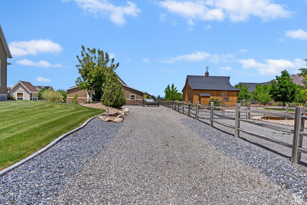 View of dirt / gravel road with an exterior structure