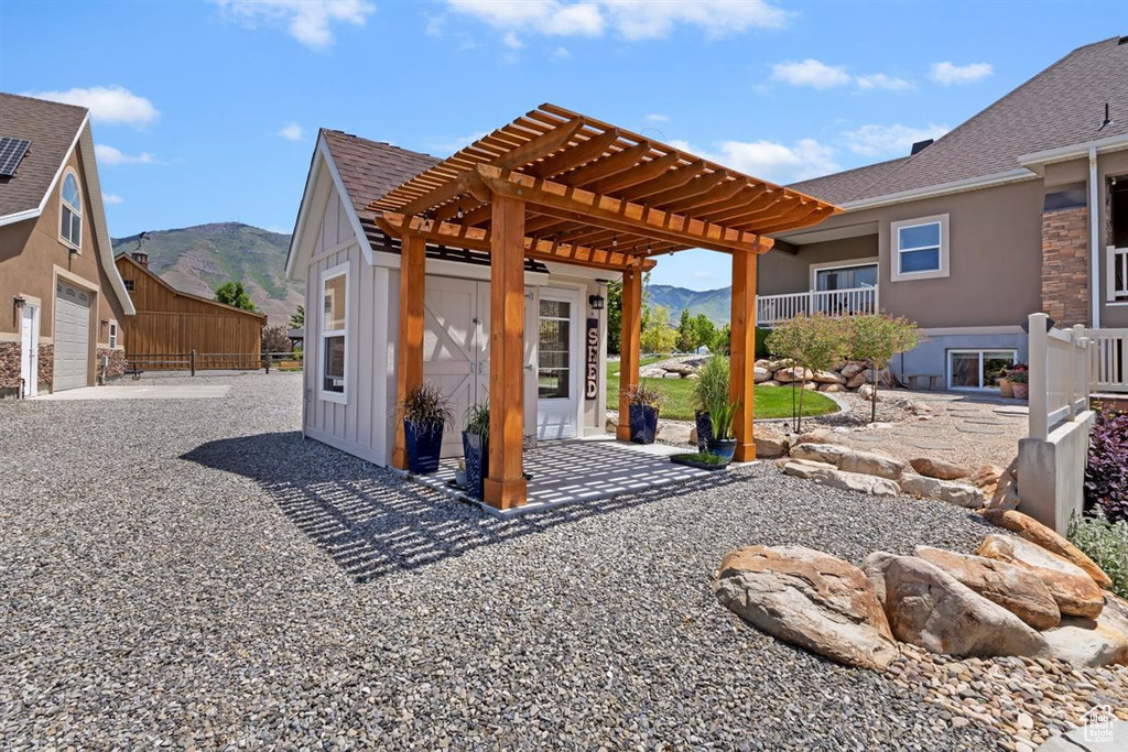 View of patio / terrace featuring a mountain view and a pergola