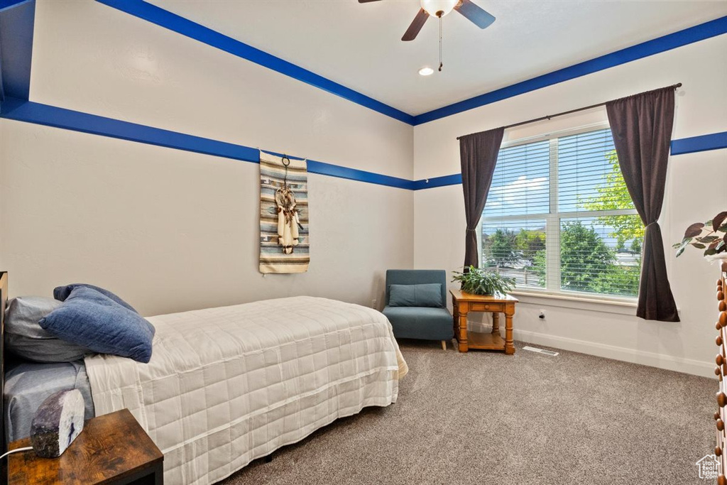 Carpeted bedroom featuring baseboards, a ceiling fan, and recessed lighting