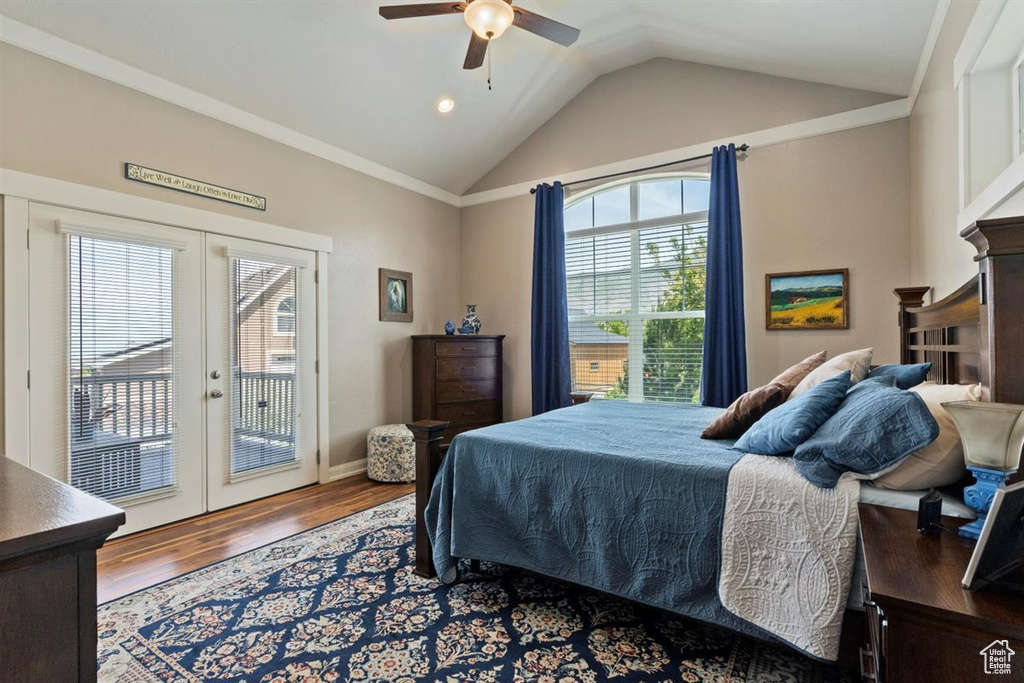 Bedroom with french doors, access to outside, lofted ceiling, wood finished floors, and ceiling fan