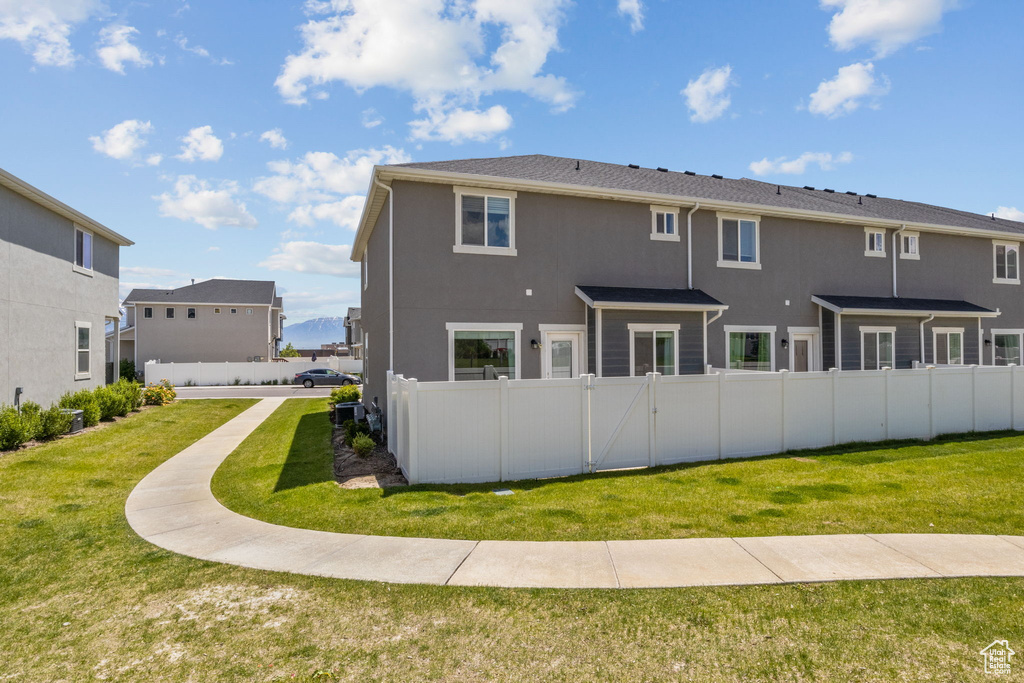 Rear view of house featuring stucco siding