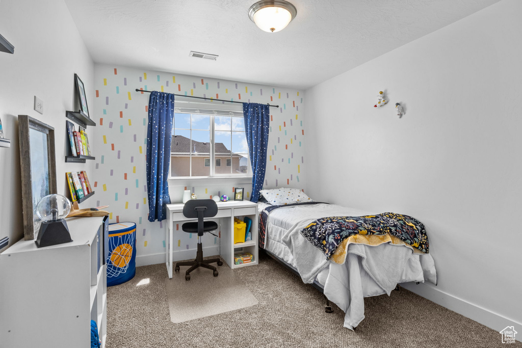 Carpeted bedroom with baseboards