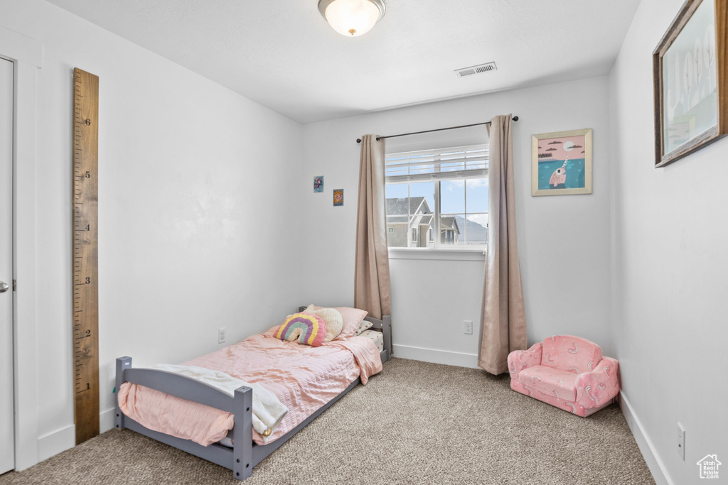 Bedroom with carpet flooring and baseboards