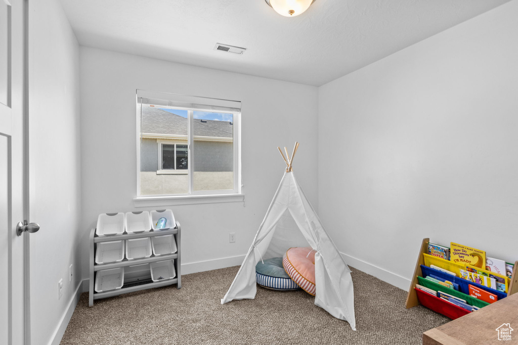 Recreation room with baseboards and carpet