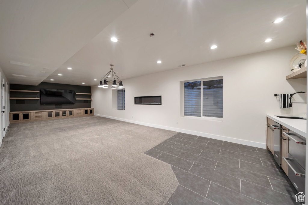 Living room featuring recessed lighting, baseboards, and dark tile patterned flooring